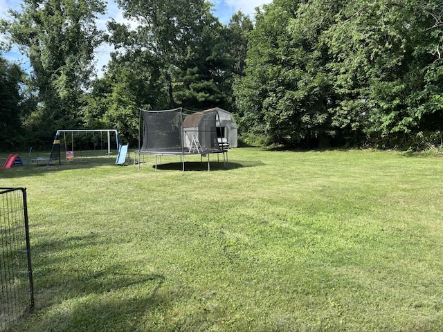 137 Apperson Rd, Battle Creek, MI 49015 - view of green lawn with a trampoline and a playground