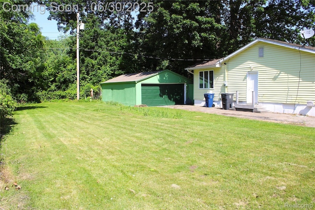 4901 Alpha Way, Flint, MI 48506 - view of grassy yard featuring a detached garage and an outdoor structure