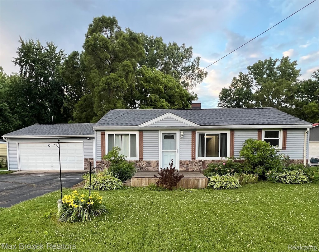 6479 Webb Dr, Flint, MI 48506 - ranch-style home with a front yard, asphalt driveway, a chimney, and stone siding