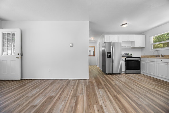 6353 Birchwood Dr, Lake, MI 48632 - kitchen with stainless steel appliances, light wood-type flooring, white cabinets, and light countertops