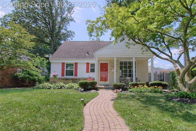 2371 Allard Ave, Grosse Pointe Woods, MI 48236 - view of front facade with a porch, a shingled roof, and stone siding