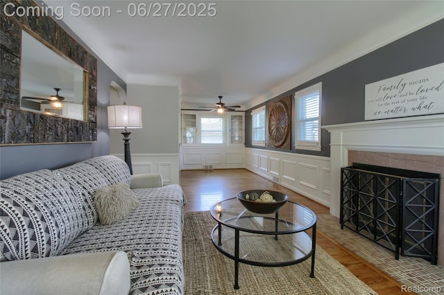2371 Allard Ave, Grosse Pointe Woods, MI 48236 - living room featuring a ceiling fan, a decorative wall, healthy amount of natural light, wood finished floors, and a wainscoted wall