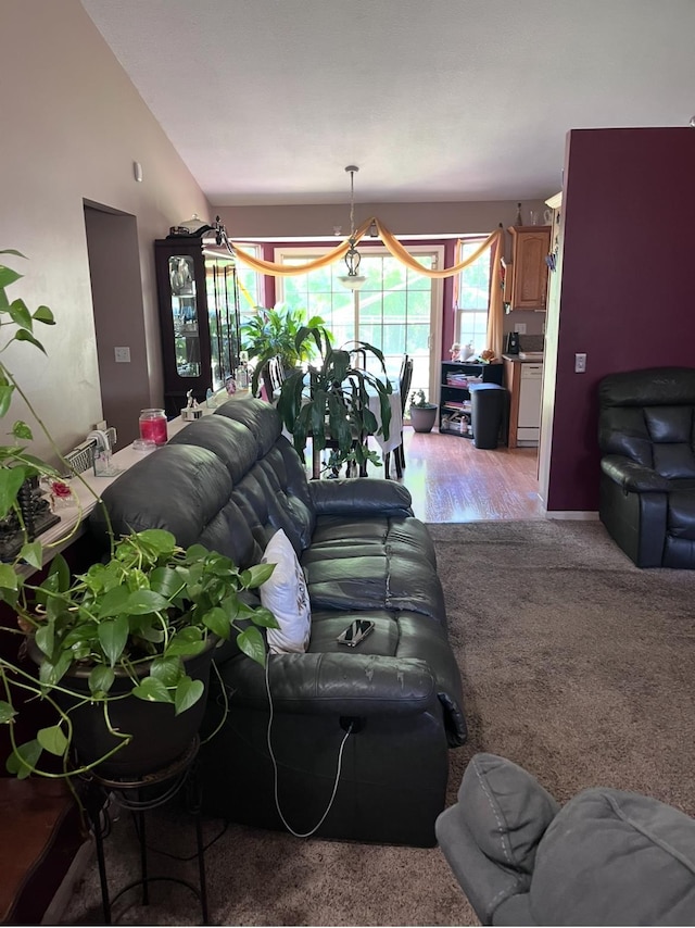 5344 Wheat Way Ave, Swartz Creek, MI 48473 - living area with vaulted ceiling, light carpet, a chandelier, and light wood finished floors