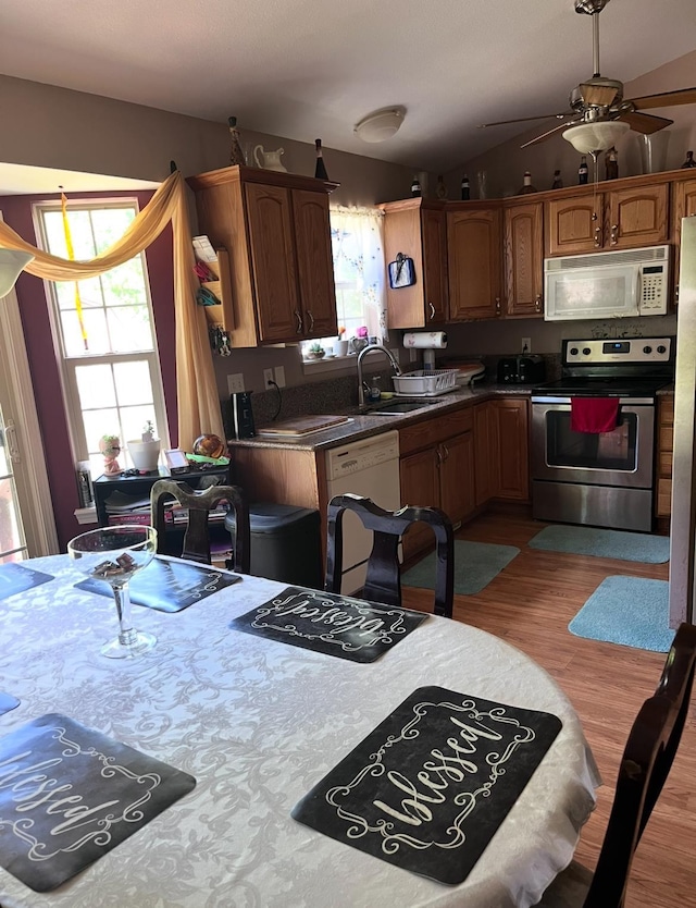 5344 Wheat Way Ave, Swartz Creek, MI 48473 - kitchen featuring white appliances, light wood-style floors, ceiling fan, lofted ceiling, and brown cabinets