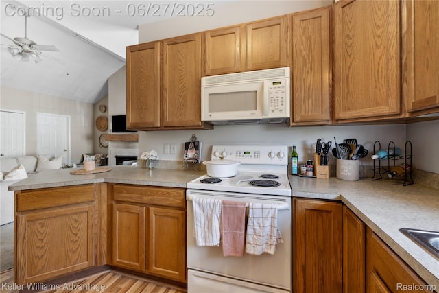 3201 Addington Dr, Commerce Twp, MI 48390 - kitchen featuring white appliances, open floor plan, a ceiling fan, a peninsula, and vaulted ceiling