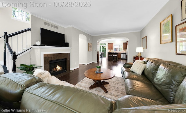 6014 Windemere Ln, Shelby Twp, MI 48316 - living area featuring dark wood-style floors, arched walkways, healthy amount of natural light, and crown molding