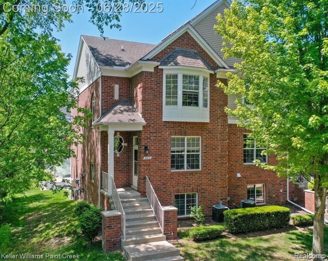 6014 Windemere Ln, Shelby Twp, MI 48316 - view of front facade with brick siding and roof with shingles