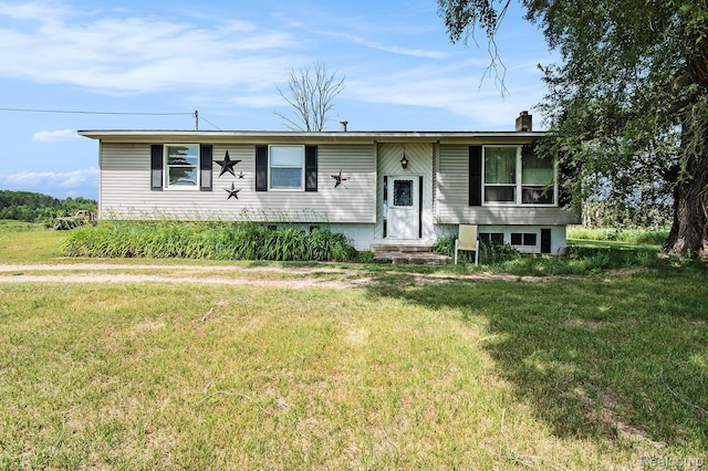 367 N Morrison Rd, West Branch, MI 48661 - view of front of home with a front yard, entry steps, and a chimney