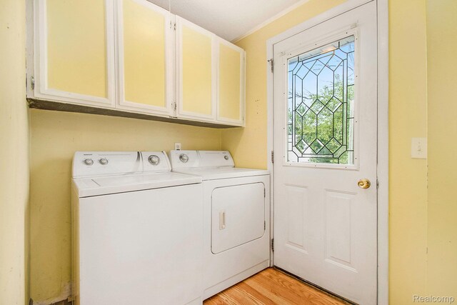 367 N Morrison Rd, West Branch, MI 48661 - washroom featuring cabinet space, washing machine and clothes dryer, and light wood-type flooring