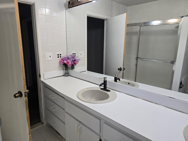 9361 W Parkway St, Detroit, MI 48239 - bathroom with vanity, tile patterned floors, a shower with door, and tile walls