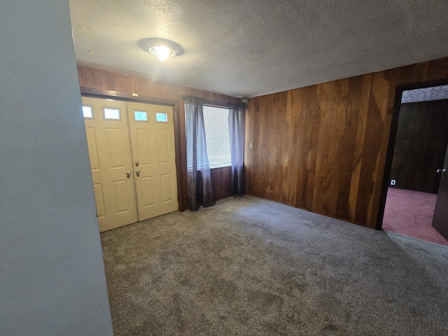 9361 W Parkway St, Detroit, MI 48239 - carpeted foyer entrance featuring wooden walls and a textured ceiling
