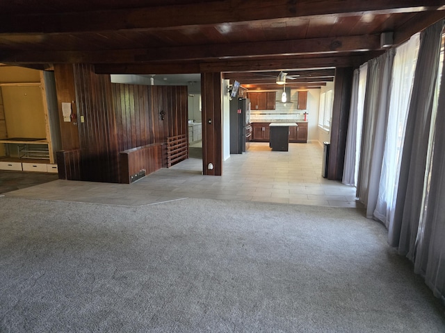 9361 W Parkway St, Detroit, MI 48239 - unfurnished living room featuring a wooden ceiling with exposed beams, light carpet, and wooden walls