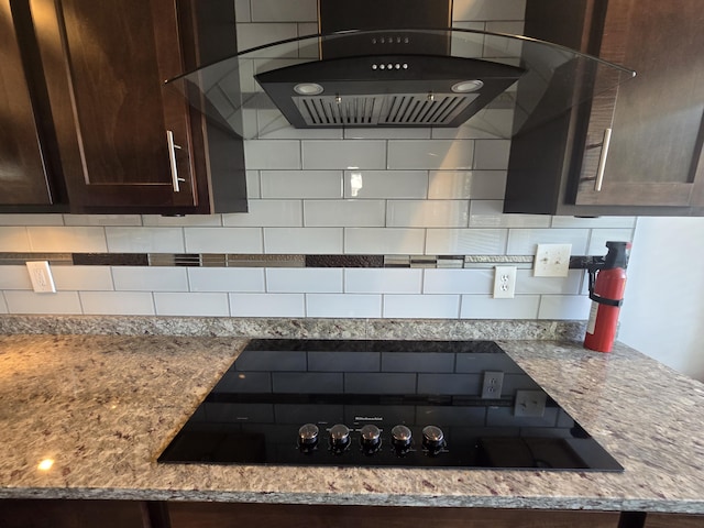 9361 W Parkway St, Detroit, MI 48239 - kitchen with range hood, black electric cooktop, dark brown cabinets, backsplash, and light stone counters