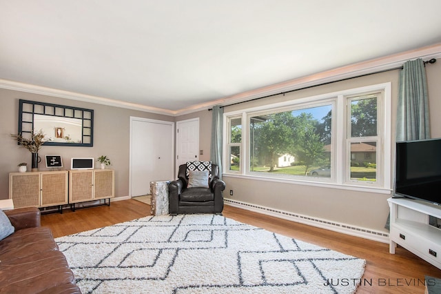 1538 10th St NW, Grand Rapids, MI 49504 - living area with baseboard heating, wood finished floors, and crown molding