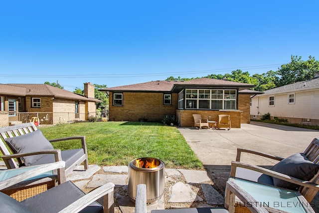 1538 10th St NW, Grand Rapids, MI 49504 - rear view of house with brick siding and a patio