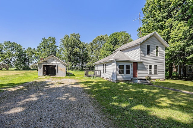 204 W Clay St, Sherwood, MI 49089 - view of front of house featuring a garage, a front yard, an outdoor structure, and driveway