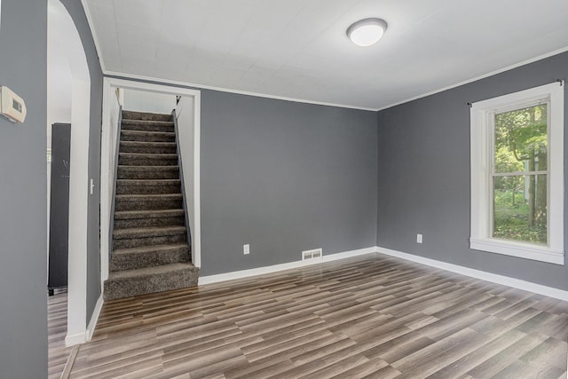 204 W Clay St, Sherwood, MI 49089 - unfurnished room with crown molding, wood finished floors, stairway, and arched walkways