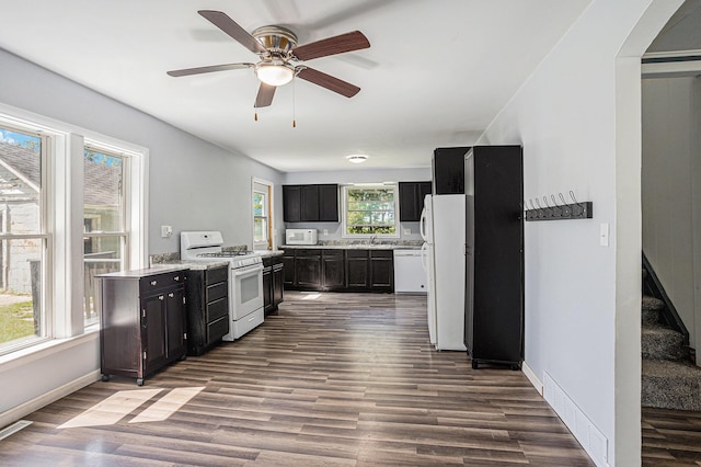 204 W Clay St, Sherwood, MI 49089 - kitchen featuring white appliances, dark cabinets, and dark wood finished floors
