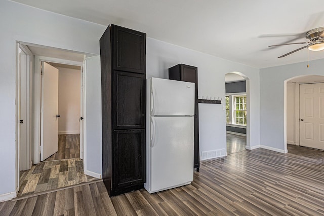 204 W Clay St, Sherwood, MI 49089 - kitchen featuring freestanding refrigerator, arched walkways, dark wood finished floors, ceiling fan, and dark cabinets