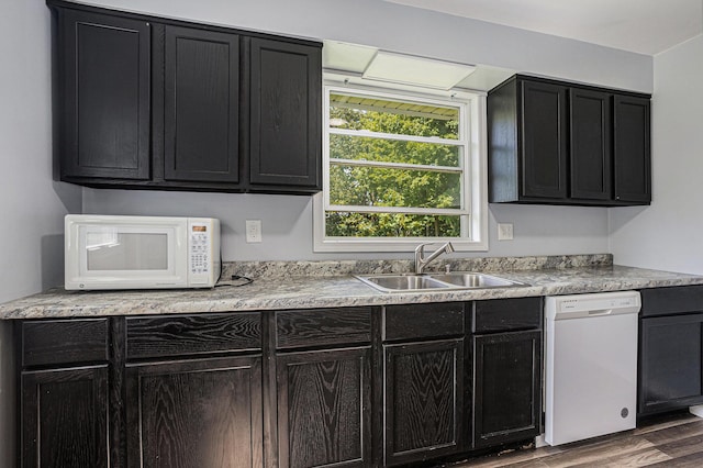 204 W Clay St, Sherwood, MI 49089 - kitchen with white appliances, dark cabinetry, wood finished floors, and light countertops