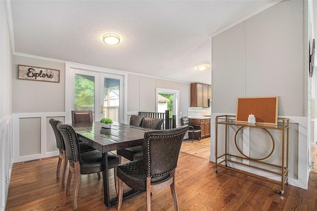 80150 46th Ave, Coloma, MI 49038 - dining room featuring crown molding, light wood-style floors, a decorative wall, and a textured ceiling