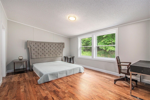 80150 46th Ave, Coloma, MI 49038 - bedroom with lofted ceiling, ornamental molding, a textured ceiling, wood finished floors, and a desk
