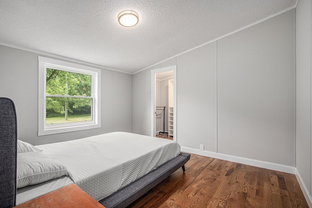 80150 46th Ave, Coloma, MI 49038 - bedroom with a textured ceiling, vaulted ceiling, wood finished floors, and ornamental molding