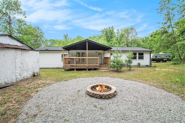 80150 46th Ave, Coloma, MI 49038 - back of property with an outdoor fire pit, a yard, and a deck
