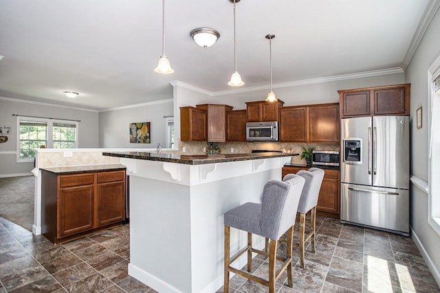 6061 Equestrian Woods Ct, Kalamazoo, MI 49009 - kitchen with appliances with stainless steel finishes, a kitchen breakfast bar, ornamental molding, a center island, and dark stone finish flooring