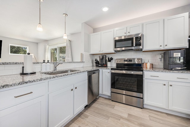 374 Lotz Ct, Wayland, MI 49348 - kitchen with appliances with stainless steel finishes, tasteful backsplash, light stone counters, and recessed lighting