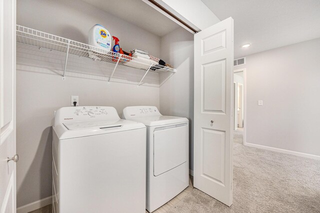374 Lotz Ct, Wayland, MI 49348 - laundry area featuring washing machine and clothes dryer and light carpet