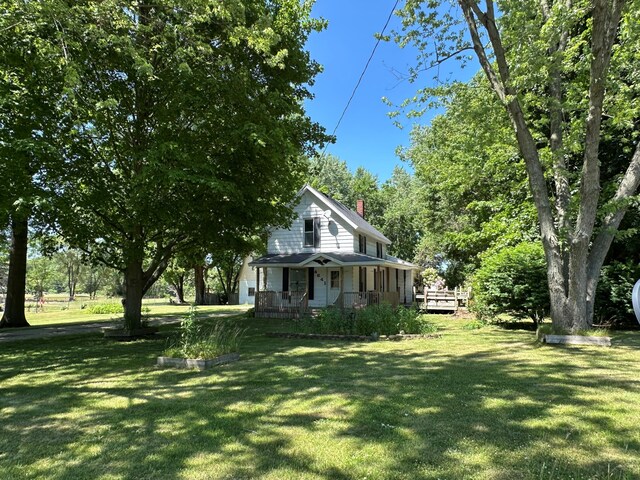 4641 Territorial Rd, Benton Harbor, MI 49022 - view of property exterior with a chimney, a yard, and covered porch
