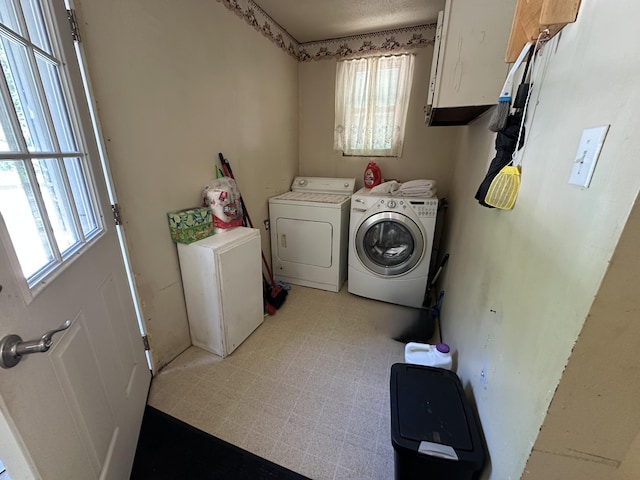 4641 Territorial Rd, Benton Harbor, MI 49022 - laundry area with separate washer and dryer, plenty of natural light, cabinet space, and light flooring