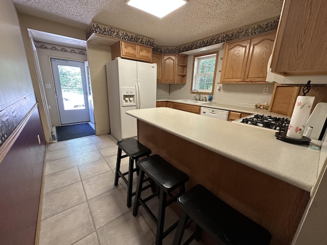 4641 Territorial Rd, Benton Harbor, MI 49022 - kitchen with white appliances, a peninsula, open shelves, light countertops, and a textured ceiling