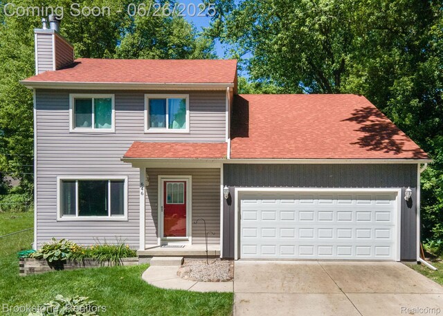 646 Alan Dr, Lake Orion, MI 48362 - traditional home with a chimney, a garage, concrete driveway, and roof with shingles
