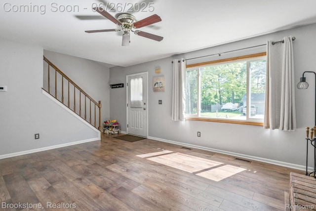 646 Alan Dr, Lake Orion, MI 48362 - entryway featuring wood finished floors, a ceiling fan, and stairway