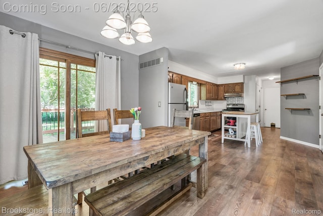 646 Alan Dr, Lake Orion, MI 48362 - dining space with a chandelier and dark wood finished floors