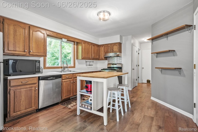 646 Alan Dr, Lake Orion, MI 48362 - kitchen featuring appliances with stainless steel finishes, under cabinet range hood, wood counters, open shelves, and wood finished floors
