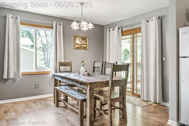 646 Alan Dr, Lake Orion, MI 48362 - dining area with wood finished floors and a chandelier