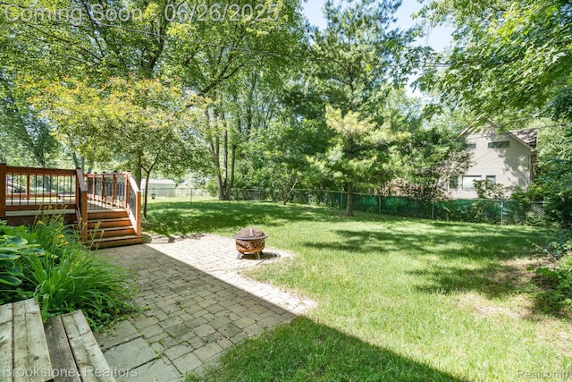 646 Alan Dr, Lake Orion, MI 48362 - fenced backyard featuring a fire pit, a deck, and a patio area