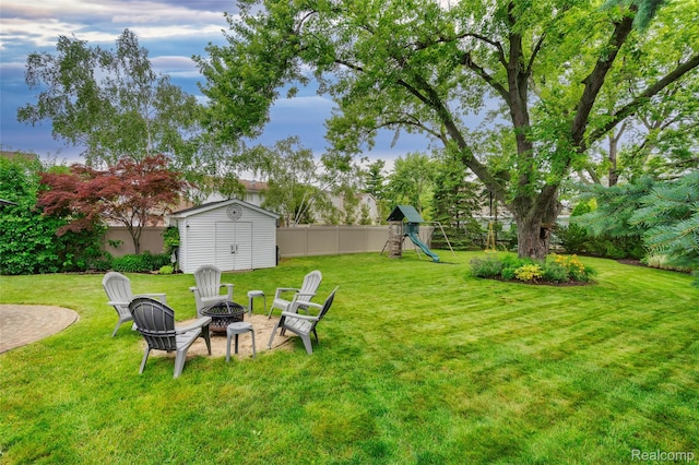 6848 Chadwick Dr, Canton, MI 48187 - view of yard featuring a fire pit, a storage unit, and a playground