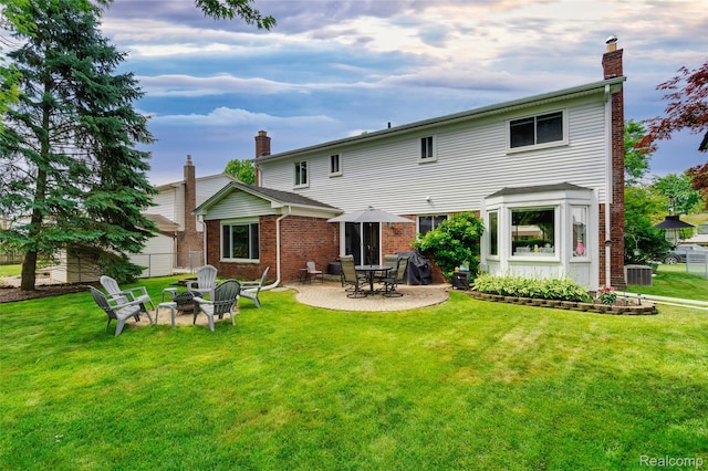 6848 Chadwick Dr, Canton, MI 48187 - back of house featuring a chimney, brick siding, a patio, and a fire pit