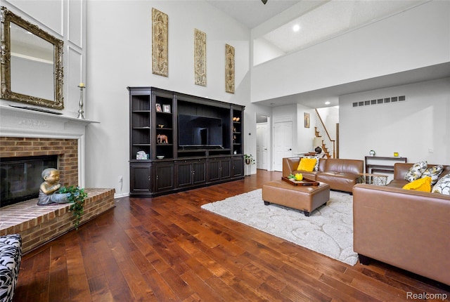1249 Lasalle Rd, Canton, MI 48187 - living room featuring high vaulted ceiling, wood finished floors, stairs, a brick fireplace, and recessed lighting