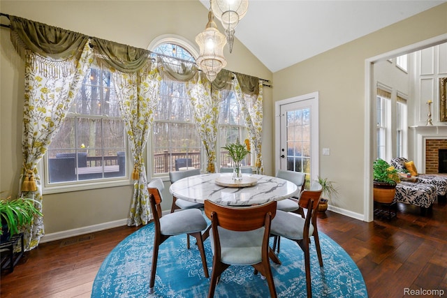 1249 Lasalle Rd, Canton, MI 48187 - dining room with vaulted ceiling, a chandelier, hardwood / wood-style flooring, and a fireplace