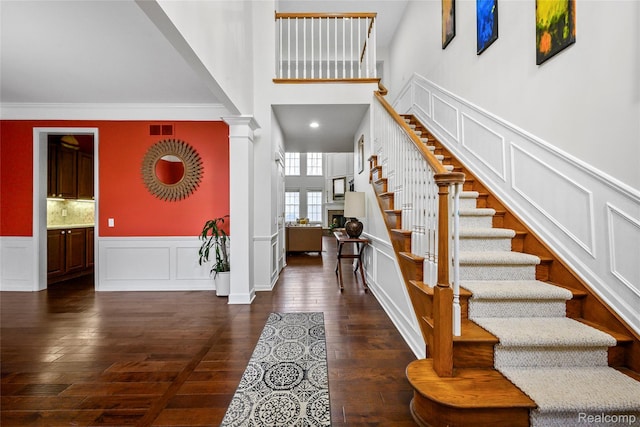 1249 Lasalle Rd, Canton, MI 48187 - foyer entrance featuring a decorative wall, decorative columns, a towering ceiling, stairs, and dark wood-type flooring