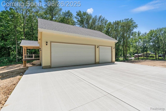 917 Chickasaw Dr, Mason, MI 48854 - garage featuring concrete driveway