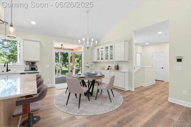 917 Chickasaw Dr, Mason, MI 48854 - dining room with light wood-style flooring, healthy amount of natural light, a chandelier, vaulted ceiling, and recessed lighting
