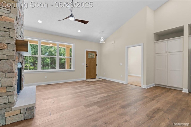 917 Chickasaw Dr, Mason, MI 48854 - unfurnished living room with a ceiling fan, a fireplace, light wood-style floors, high vaulted ceiling, and recessed lighting