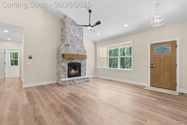 917 Chickasaw Dr, Mason, MI 48854 - unfurnished living room with wood finished floors, ceiling fan, a fireplace, and high vaulted ceiling