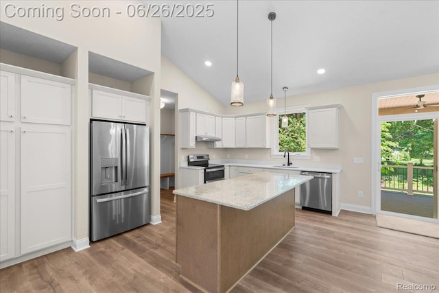 917 Chickasaw Dr, Mason, MI 48854 - kitchen featuring stainless steel appliances, light wood-style floors, white cabinets, under cabinet range hood, and a center island